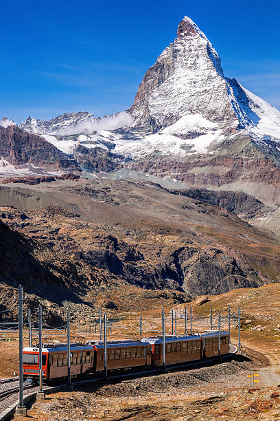 istock Matterhorn peak against  train in Swiss Alps 499366076