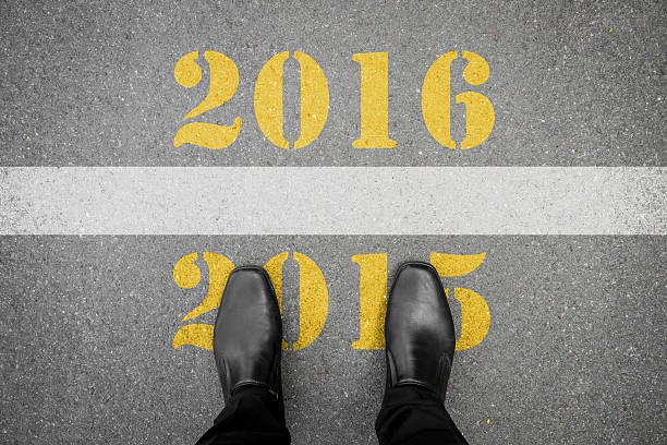 istock Shoes standing in front of new year 2016 line 499367782