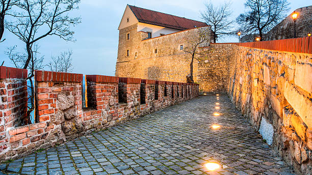one part of medieval castle in Bratislava, capital city of Slovakia in winter evening with lamps lit