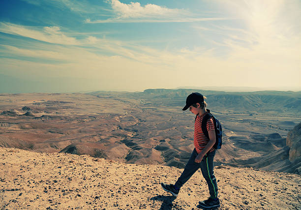 istock boy hiking in the desert 499372950