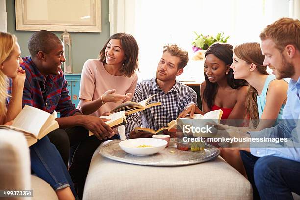 Group Of Friends Taking Part In Book Club At Home Stock Photo - Download Image Now - Book Club, Book, Reading