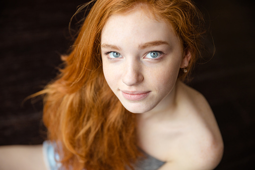 Portrait of a beautiful redhead female teenager looking at camera