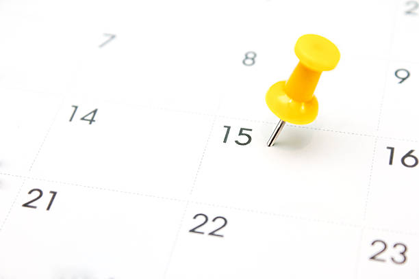 istock Yellow pin on White Calendar Closeup shot 499373700