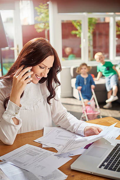 istock young mum pays over the phone 499374316