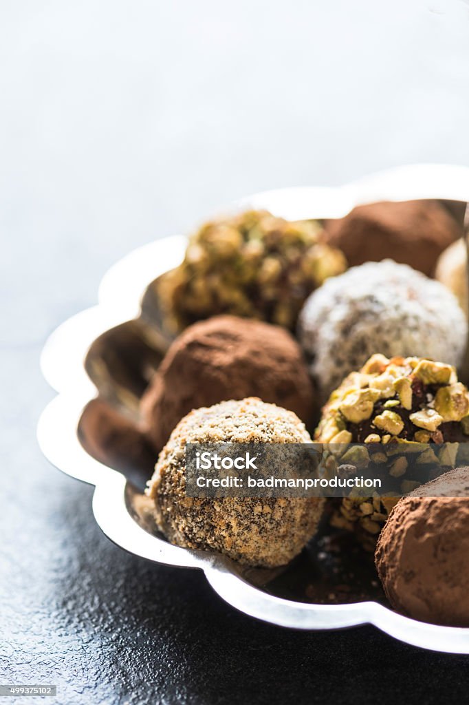 Variety of sweet homemade chocolate pralines Variety of sweet homemade chocolate pralines in the plate,selective focus 2015 Stock Photo