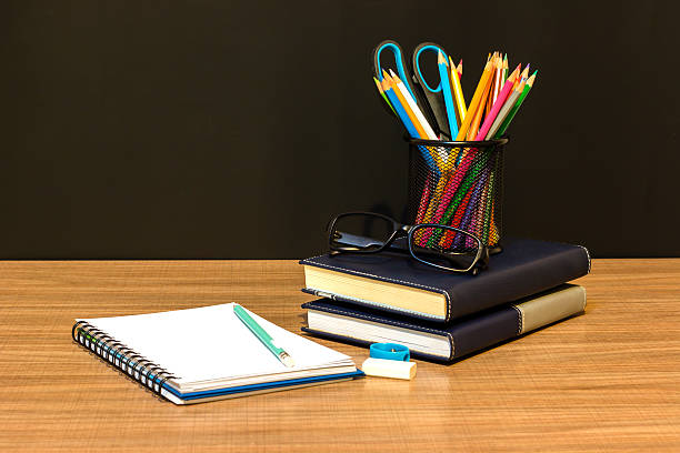 istock Teacher's desk with a color pencil, notebook and other equipment. 499375968