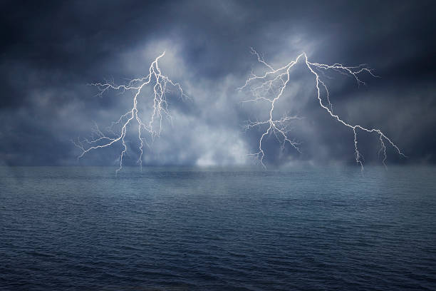 lightnings in dark sky and sea stock photo