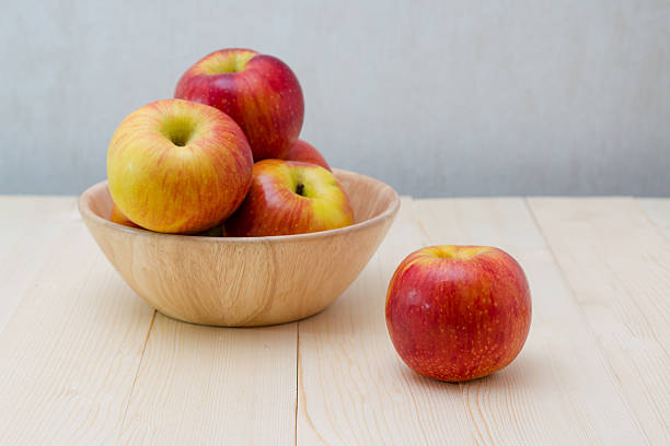 istock Red apple in wooden plate 499376104