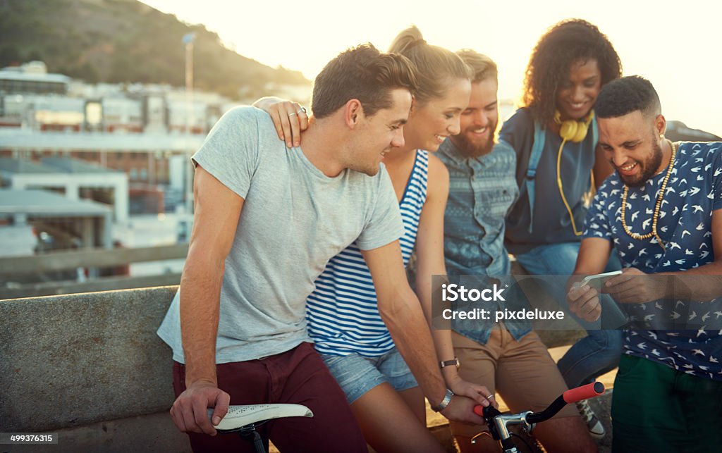 Three cheers for wireless technology A group of young adults standing outside watching a video from a cellphonehttp://195.154.178.81/DATA/i_collage/pu/shoots/784346.jpg 20-29 Years Stock Photo