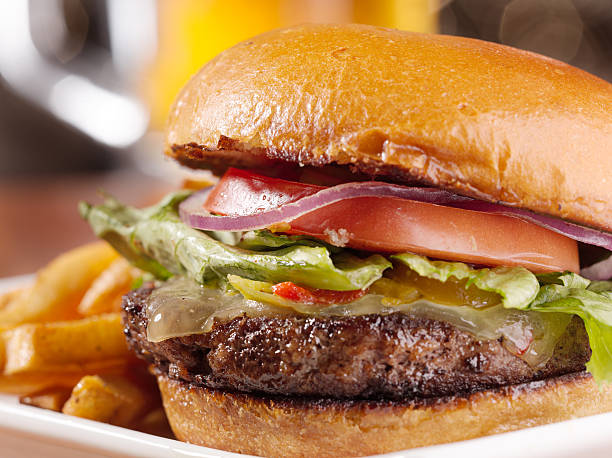 istock gourmet cheeseburger with mug of beer in background 499376611