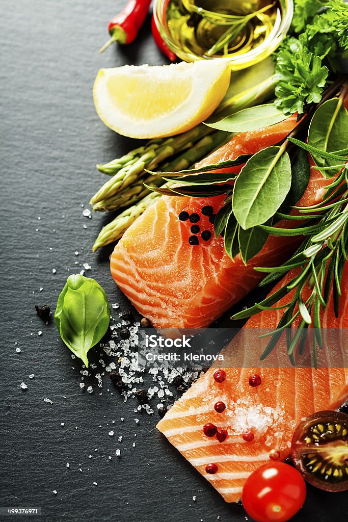 Delicious  portion of  fresh salmon fillet  with aromatic herbs, Delicious  portion of fresh salmon fillet  with aromatic herbs, spices and vegetables - healthy food, diet or cooking concept Backgrounds Stock Photo