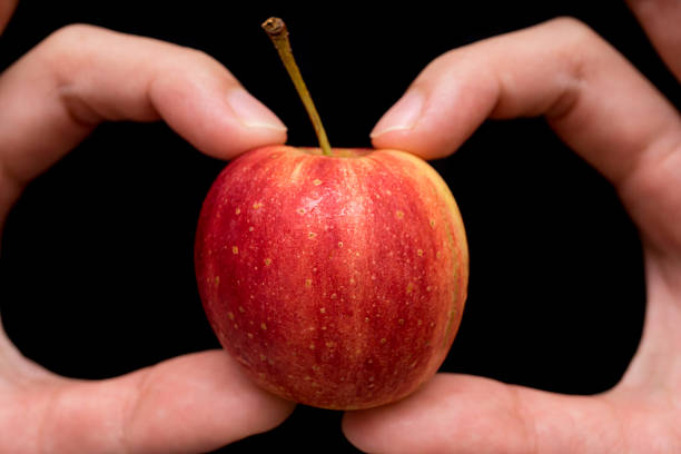 istock Small Apple hold in hand , close up 499377350