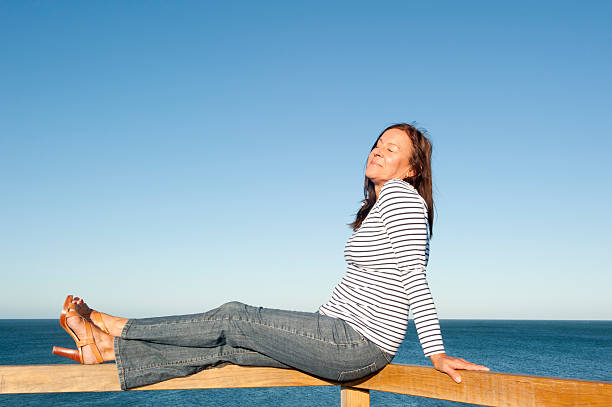 istock Sexy mature woman ocean background 499377664