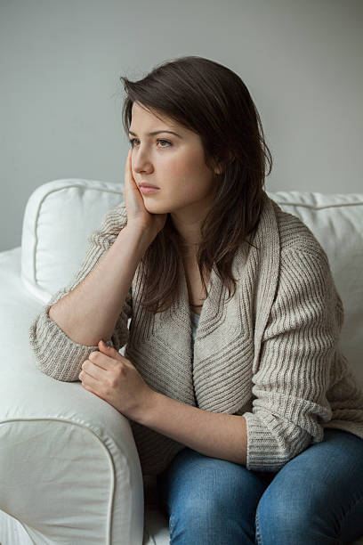istock Worried girl sitting alone 499377704