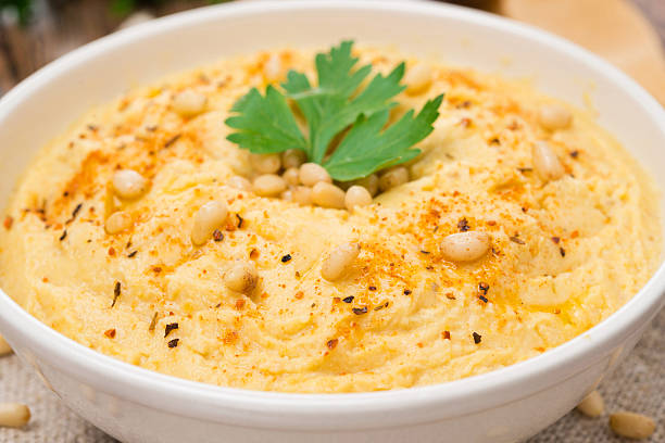 istock Hummus with pine nuts in a bowl, close-up, selective focus 499378301