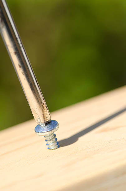 Close up of unrecognizable carpenter using drill while working on furniture in a workshop.
