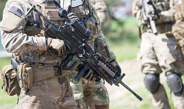 istock soldier with rifle in the forest 499379157