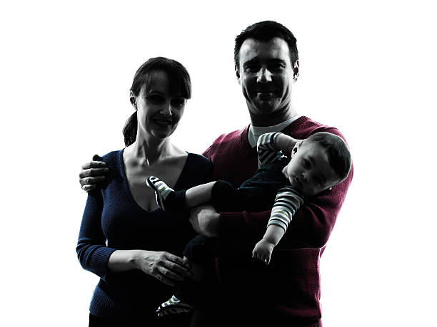 istock parents with baby portrait silhouette 499379221