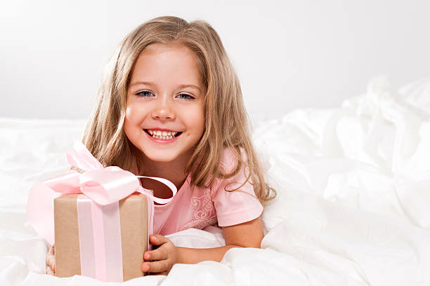 istock Happy girl with pink gift box 499379520