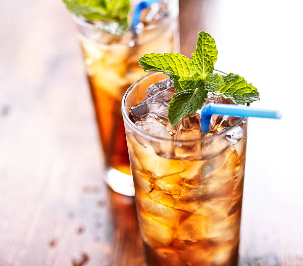iced tea with blue straw and mint garnish