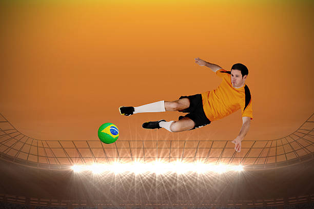 istock Football player in orange jumping 499382875