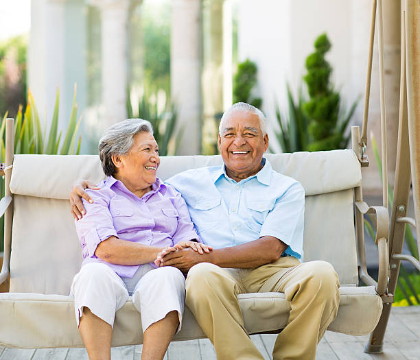 istock Happy latin couple sitting on swing 499383003