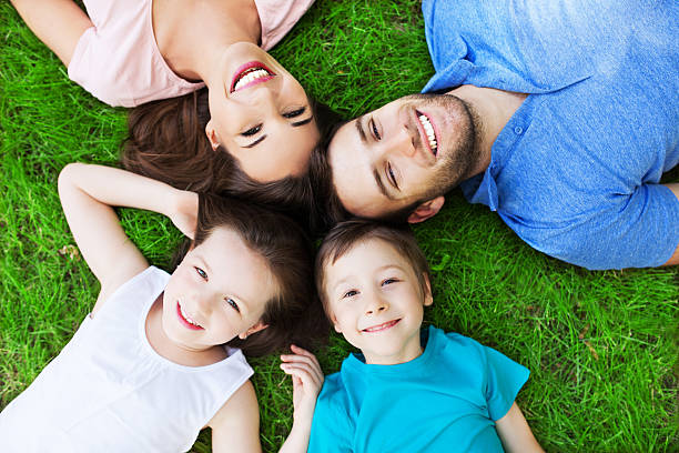 istock Young family lying on grass 499383013