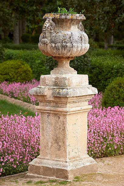 istock Garden with column, purple flowers and forest 499384145