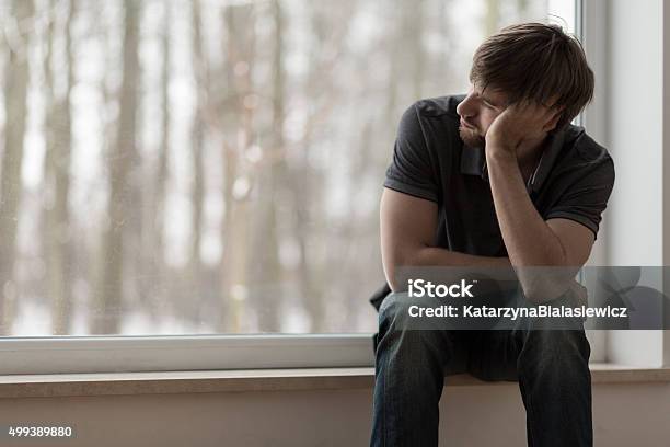 Miserable Man Sitting And Thinking Stock Photo - Download Image Now - Men, Depression - Sadness, Sadness