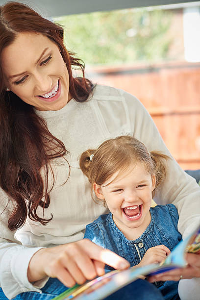 istock mother daughter book reading fun 499390206