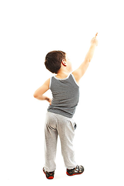 istock Back view of little boy points at wall. Rear view 499391190
