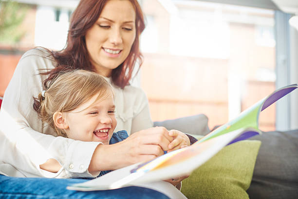 istock mother and daughter reading a book together 499396310