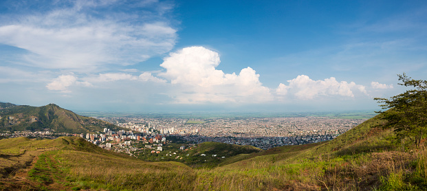 Cali, Colombia - March 6, 2015: Aerial panorama of the city of Cali taken from the top of Cristo del Rey against a blue sky. Colombia 2015