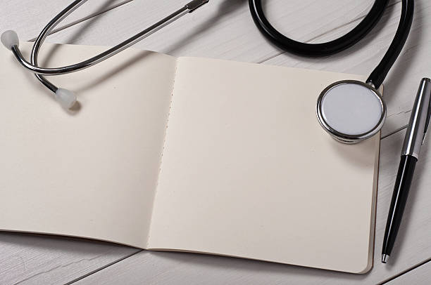 istock open notebook with blank pages with stethoscope, pen and glasses 499397766