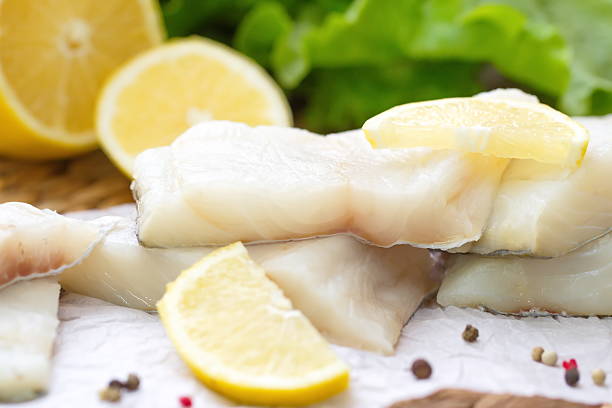 istock Raw fish with vegetables, lemon and seasonings 499398970