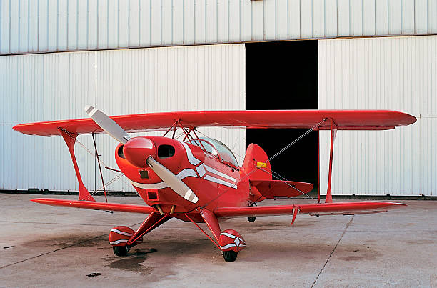 istock Red aeroplane and hangar in aerodrome 499400289