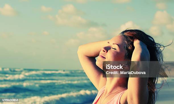 Woman At Seaside With Hands In Hair Stock Photo - Download Image Now - Adult, Adults Only, Auto Post Production Filter