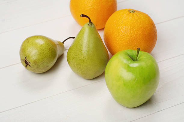 Ripe green apple, oranges with pears