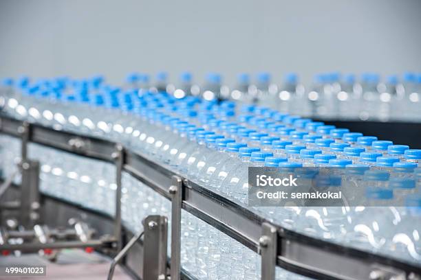 Plastic Bottles On Conveyor Belt Stock Photo - Download Image Now - Activity, Blue, Bottle Cap