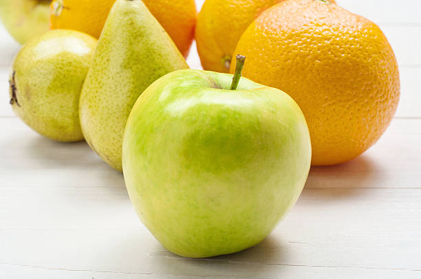 istock Closeup ripe green apple, oranges with pears 499401122