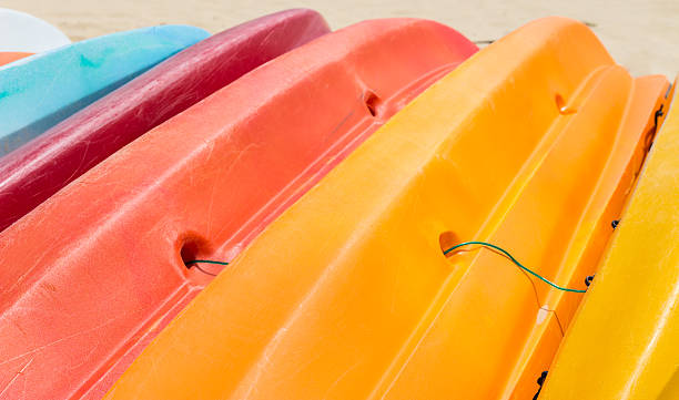 istock Colorful kayaks orderly dock on the beach 499401859