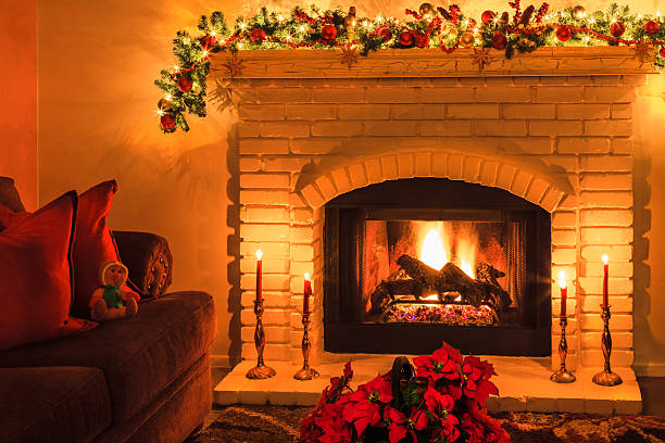 istock Christmas brick arched fireplace with fire, Poinsettias,candles (P) 499402270