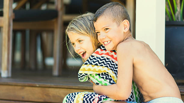 istock Brother and sister siblings cuddling 499402468