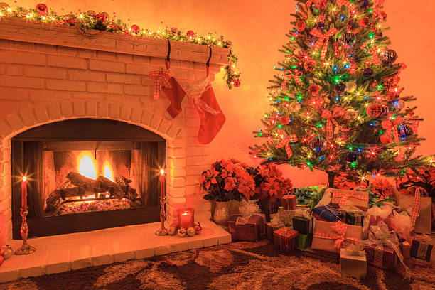 istock Christmas Tree with lit fireplace, ornaments, lights, presents (P) 499402510