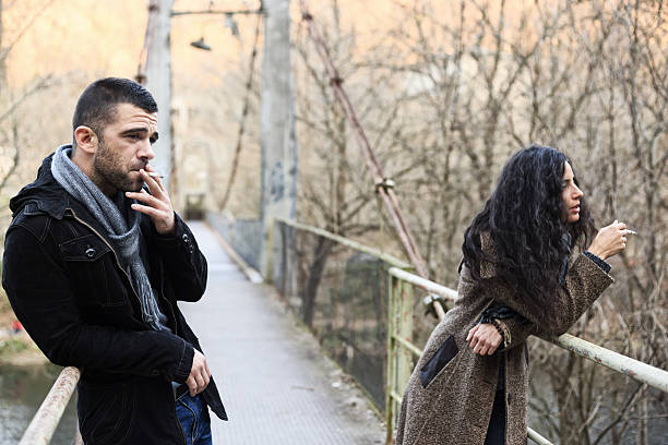 istock Young couple enjoying a cigarette on the bridge 499402684