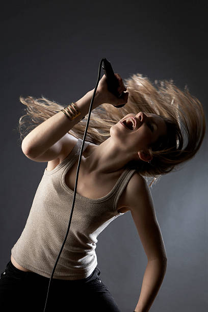 istock Girl Tossing Hair While Singing In Studio 499403837