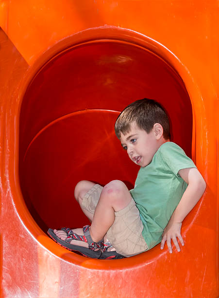 istock Boy Entering a Tube Slide 499404321