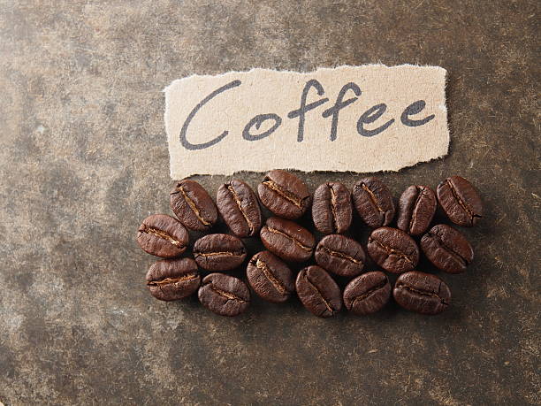 istock Coffee crop beans with paper on wood texture 499404767