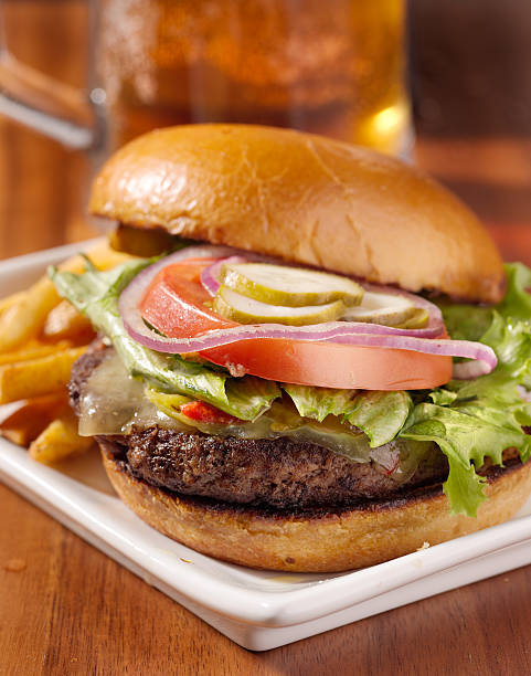 istock cheeseburger with mug of beer in background 499406627