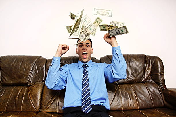 istock Young man with rain of money 499406989